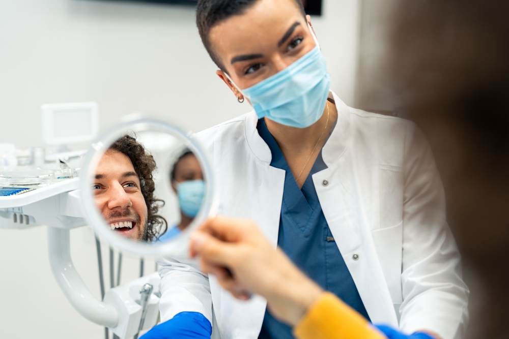 Patient smiling during dental checkup – Ideal Dental Houston TX