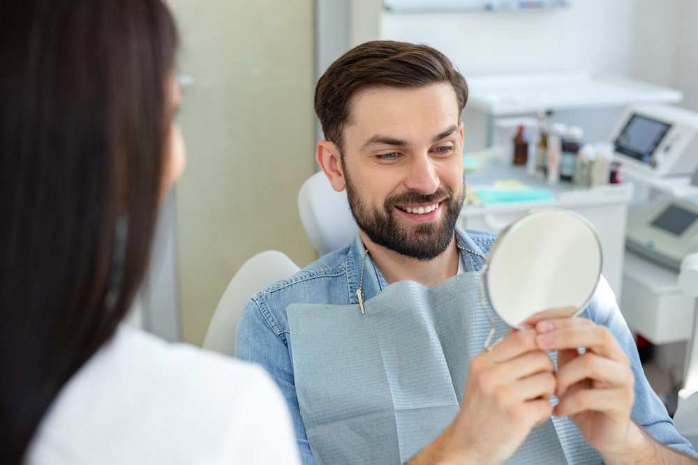 Patient smiling during dental checkup – Ideal Dental Houston TX