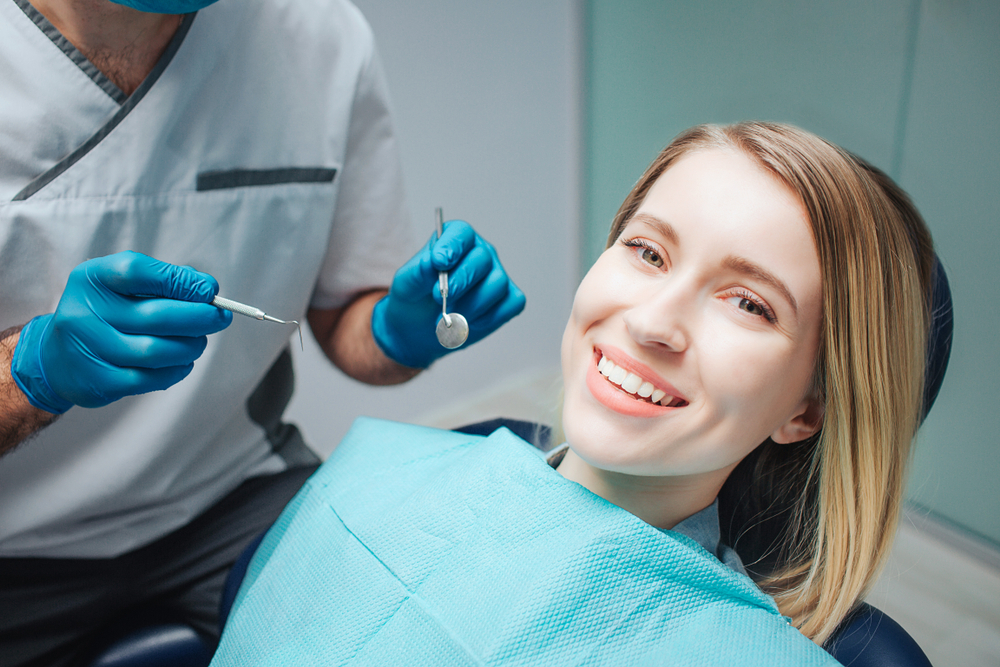 Patient smiling during dental checkup – Ideal Dental Houston TX